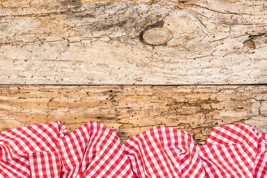 Old wooden table background rustic texture, with red checkered tablecloth, high angel view