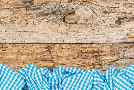 Vintage wooden table background rustic texture, with blue checkered tablecloth, high angel view