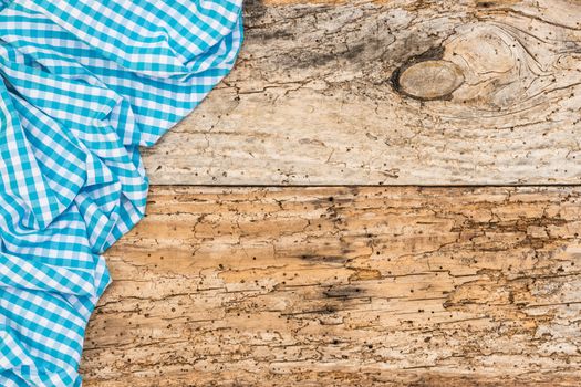 Vintage wooden table background rustic texture, with blue checkered tablecloth, high angel view