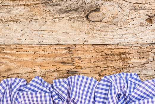 

Wooden table background rustic texture, with blue checkered tablecloth, high angel view