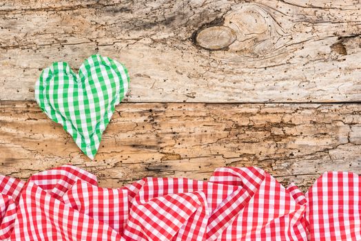 Green rustic heart on vintage wood background with copy space