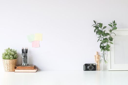 Mockup workspace desk and copy space books,plant and coffee on white desk.
