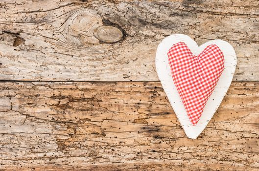 Romantic red heart on rustic old wooden background for Valentine card with copy space