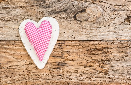 Romantic pink heart on rustic old wooden background for Valentine card with copy space

