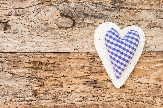 Blue heart on rustic old wooden background with copy space