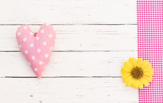 Cute pink heart and blossom on white wooden background with copy space