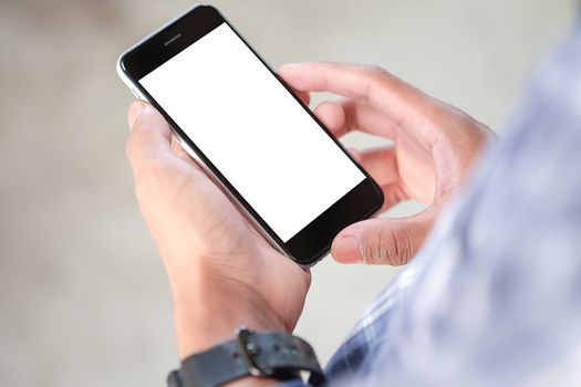 Cropped shot view of man hands holding smart phone with blank copy space screen for your text message or information content, female reading text message on cell telephone during in urban setting. 