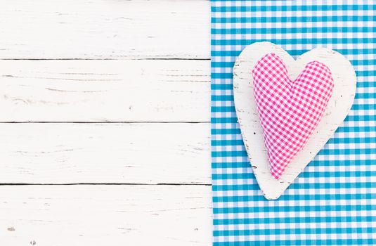 Rustic pink heart on white wooden background with copy space