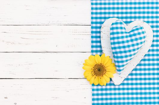 Baby boy birthday greeting card background with blue heart, yellow blossom and copy space


