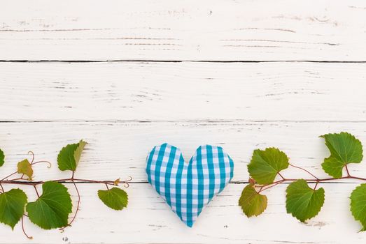 Green vine leaves border on white wood background for wine tasting event celebration 