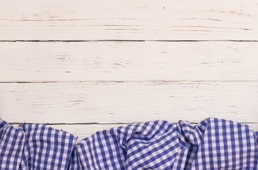 White wooden table background rustic texture, with blue checkered tablecloth, high angel view

