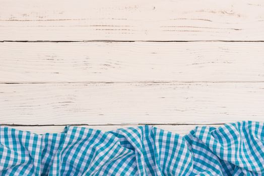 White wooden table background rustic texture, with blue checkered tablecloth, high angel view

