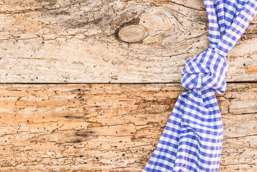 Wooden table background rustic texture, with blue checkered tablecloth, high angel view

