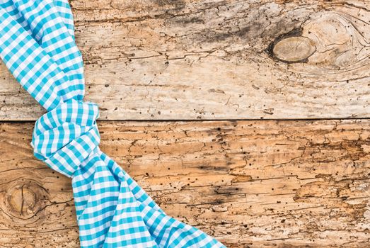 Wooden table background rustic texture, with blue checkered tablecloth, high angel view