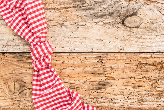 Wooden table background rustic texture, with red checkered tablecloth, high angel view

