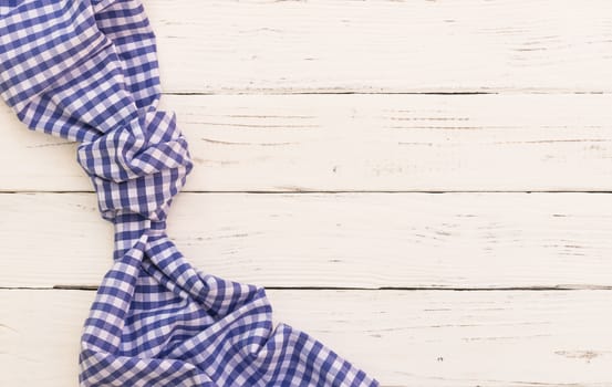 White table background with blue checked tablecloth, top view