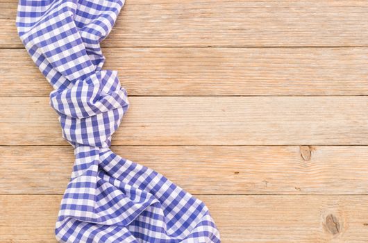 Wood table background with blue checkered tablecloth, high angel view