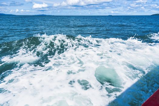 Water blue ocean splash and boat in the sea way ,Waves splashing on the side of ship