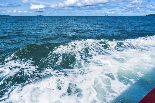 Water blue ocean splash and boat in the sea way ,Waves splashing on the side of ship