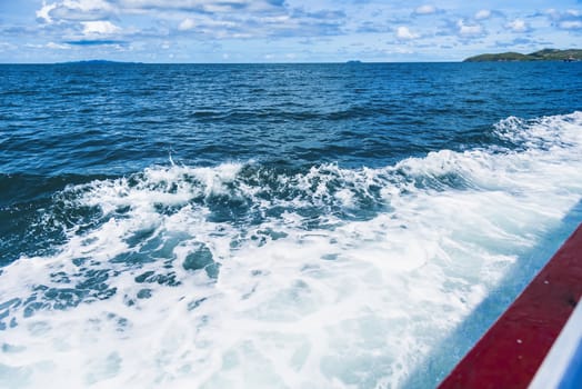 Water blue ocean splash and boat in the sea way ,Waves splashing on the side of ship