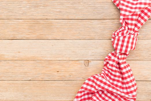 Wood table background with red checkered tablecloth, high angel view