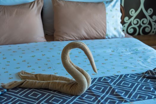 Swan shaped towel on the bed.concept travel.