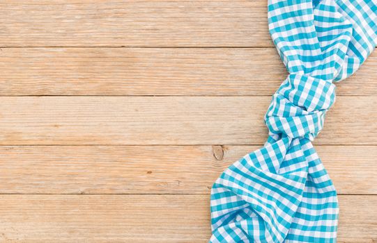 Wooden table background with blue checkered tablecloth, high angel view