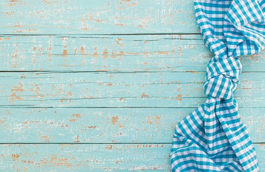 Blue wood table background rustic texture, with blue checkered tablecloth, high angel view

