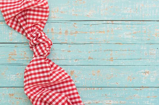 Blue wooden table background rustic texture, with red checkered tablecloth, high angel view