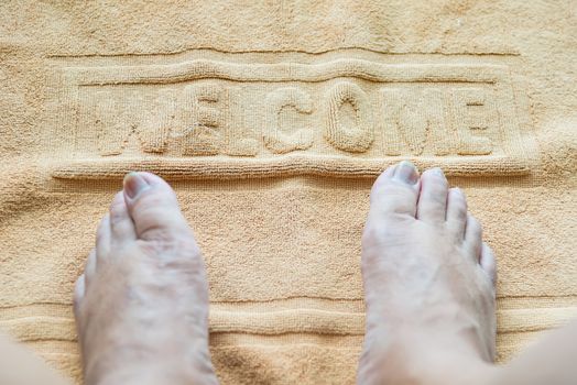 Foot towel with welcome sign on the bathroom floor