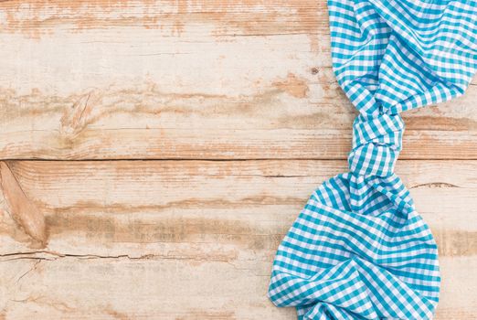Wooden table background rustic texture, with blue checkered tablecloth, high angel view