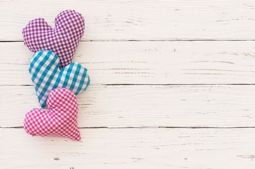 Hearts border on white wooden background with copy space