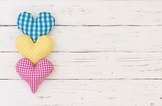 Three colorful hearts border on white background with copy space