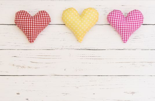 Romantic fabric hearts border in red, yellow and pink color for Valentine card background