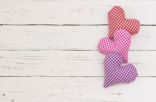 Valentines day background with love hearts on white wood