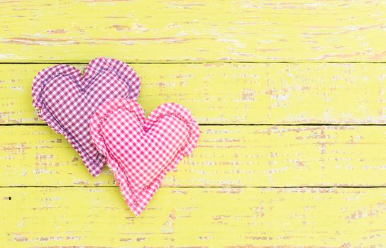 Pink and purple heart on wooden background with copy space