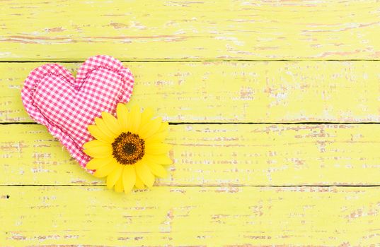 Rustic pink heart with flower on wooden background with copy space