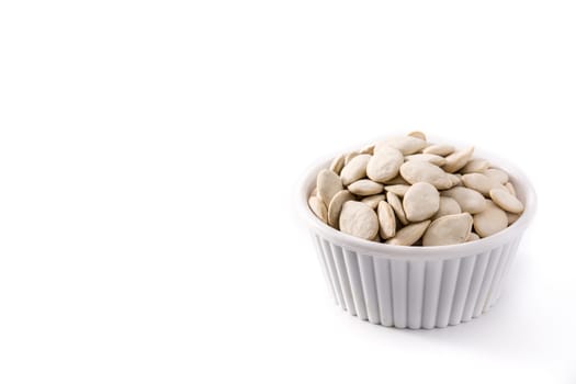 Pumpkin seeds in bowl isolated on white background