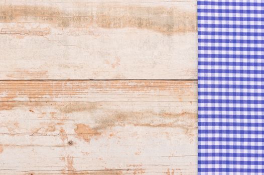 

Wooden table background rustic texture, with blue checkered tablecloth, high angel view