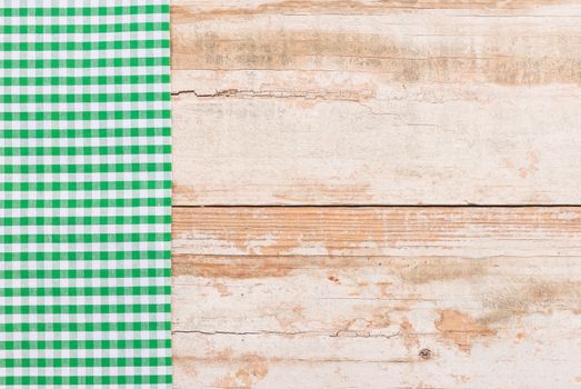 Wooden table background rustic texture, with green checkered tablecloth, high angel view

