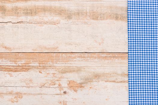 Wooden table background rustic texture, with blue checkered tablecloth, high angel view