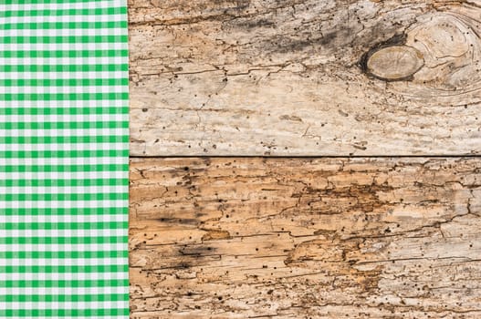 Wooden table background rustic texture, with green checkered tablecloth, high angel view