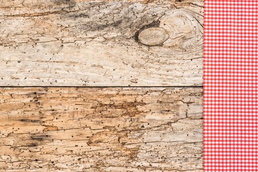 Old wooden table background rustic texture, with red checkered tablecloth, high angel view