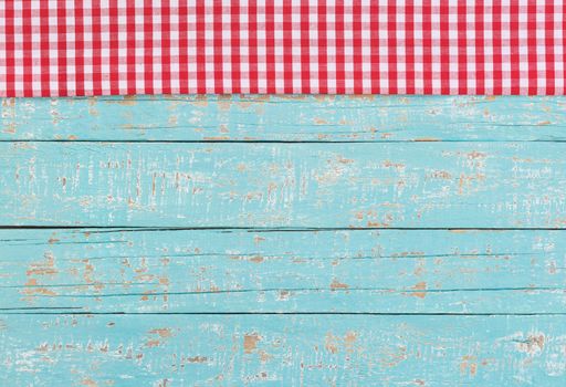 Blue table background with rustic red tablecloth

