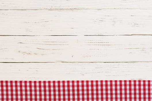 Rustic white kitchen table background with red checked tablecloth