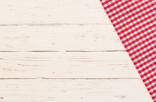 Rustic white kitchen table with red checked tablecloth and serving size