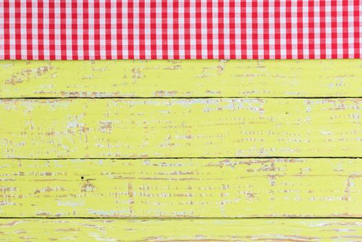 Rustic green kitchen table background with red checked tablecloth