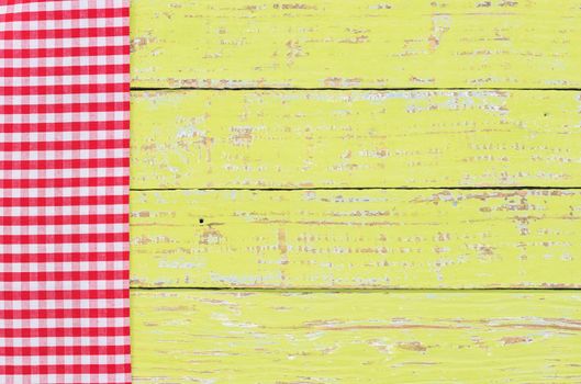 Green table background with rustic red tablecloth