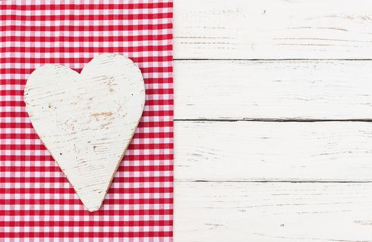 White heart on red fabric an white wood with copy space