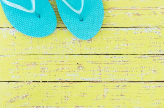 Summer holiday concept background with turquoise beach sandals on wooden deck 